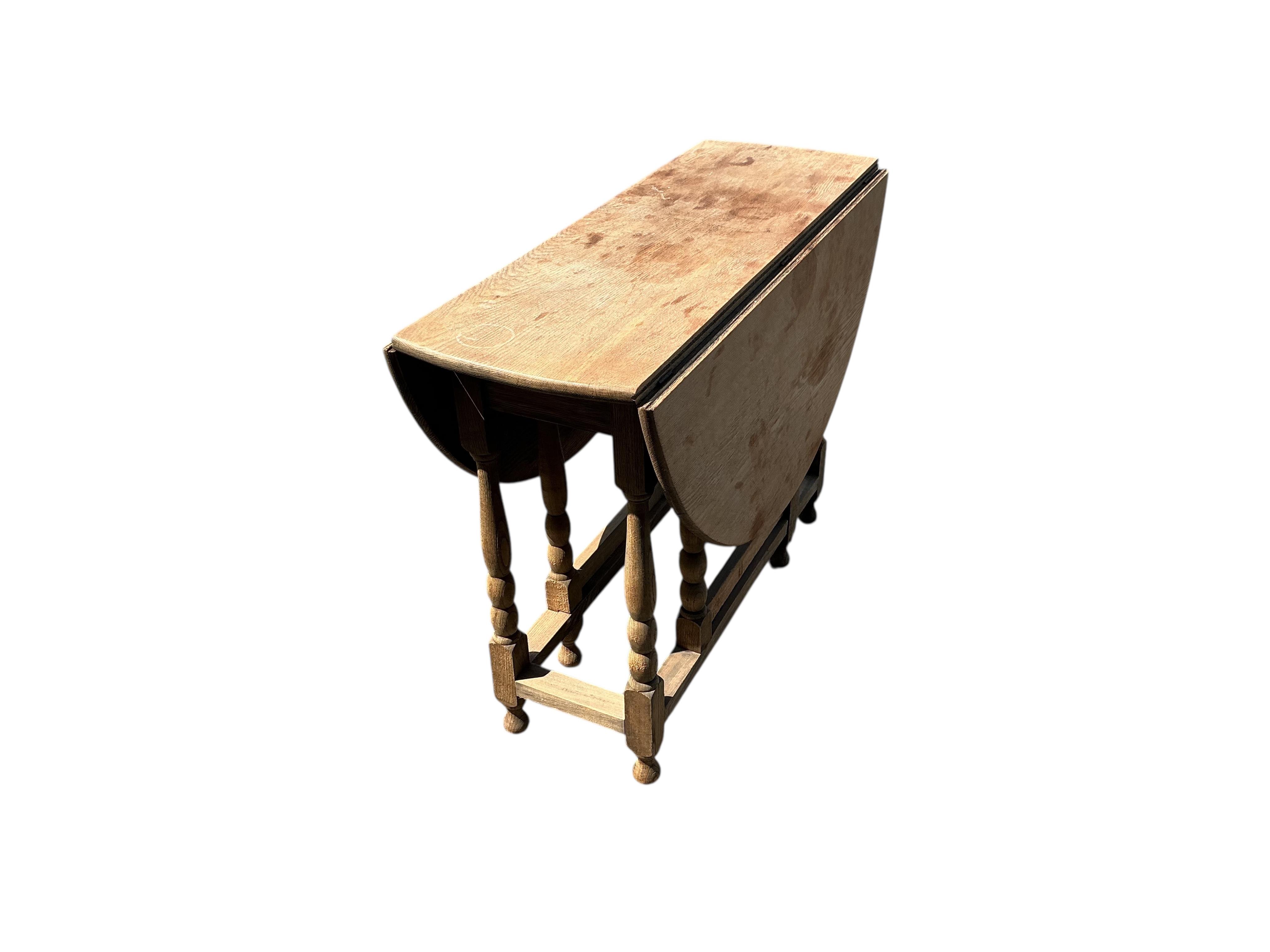 A bleached oak gateleg table, width 99cm, depth 37cm, height 72cm